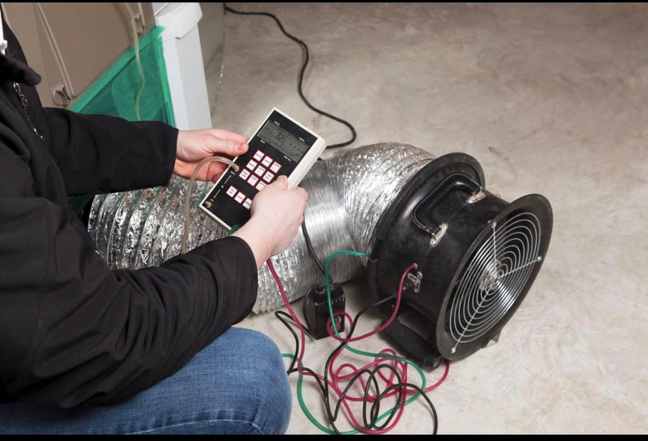 Technician performing duct leakage testing on HVAC ductwork