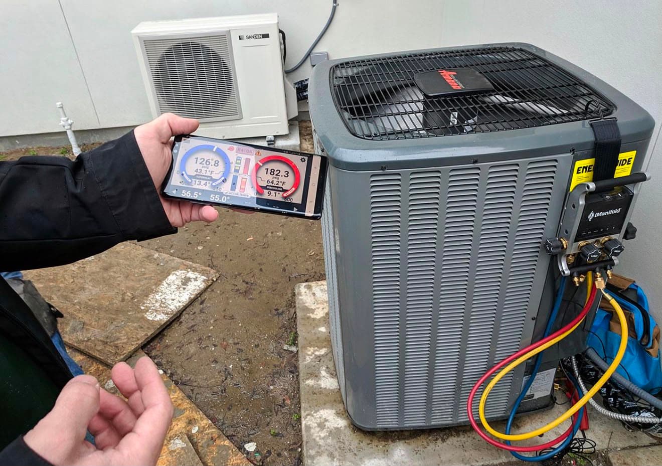 Technician confirming refrigerant charge on HVAC system